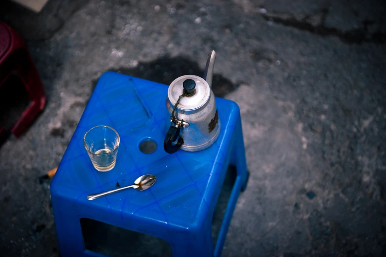 a blue container with a measuring cup and spoon