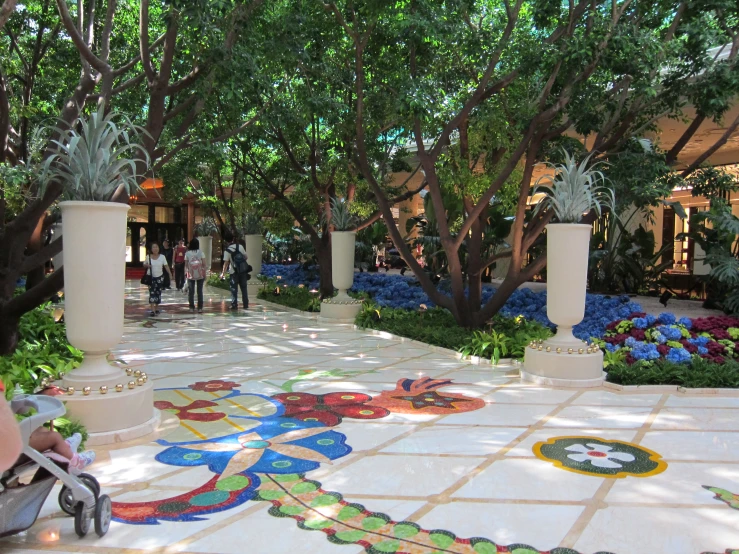 people walking through a center area on tiled floors