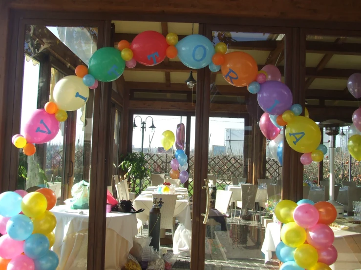 a group of balloons floating in the air at an event