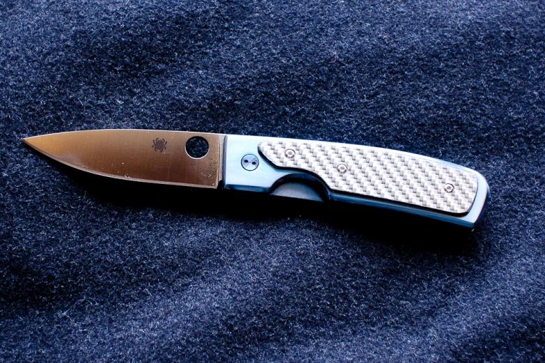 a close up of a knife on a blue background