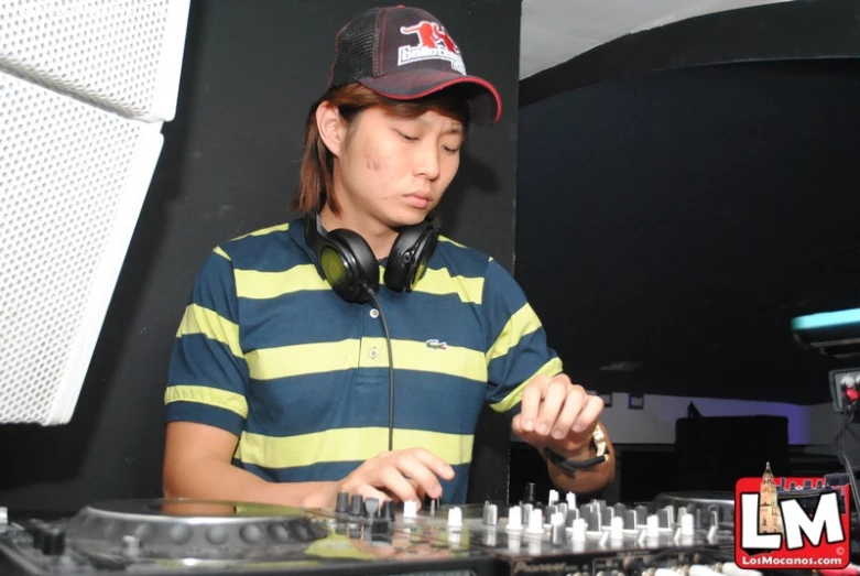 a young man in headphones playing dj equipment