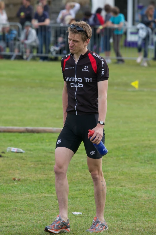 a man with sports gear standing on grass