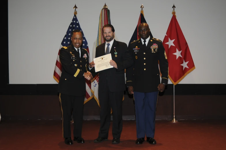 four military officers in front of flags standing next to each other