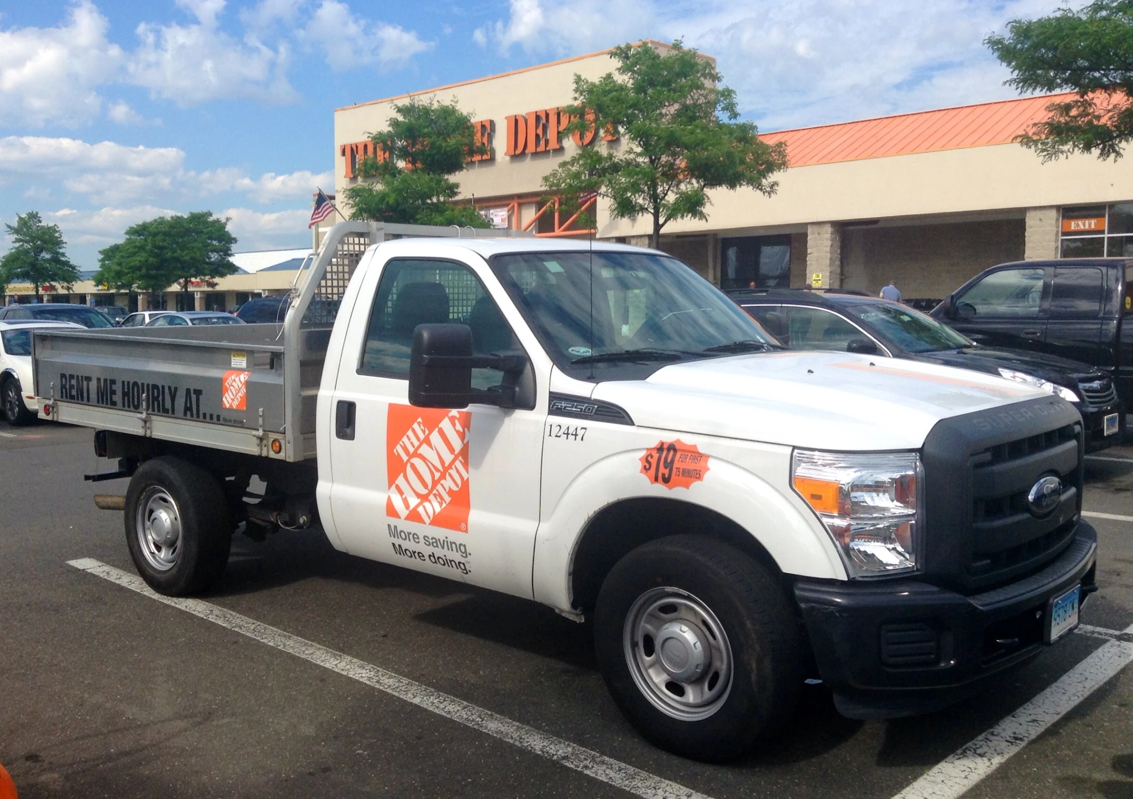 a white utility truck is parked in a parking lot