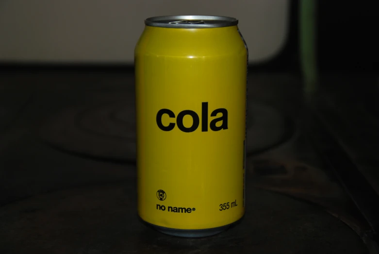 a close up of a coca - cola can on a table