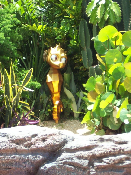 a close up of an outdoor statue near plants