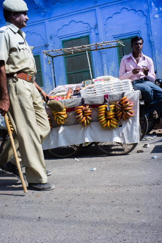 a man walking near a table with bananas and water