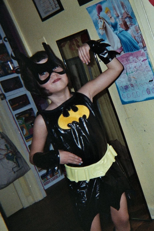 a small child dressed as a batman