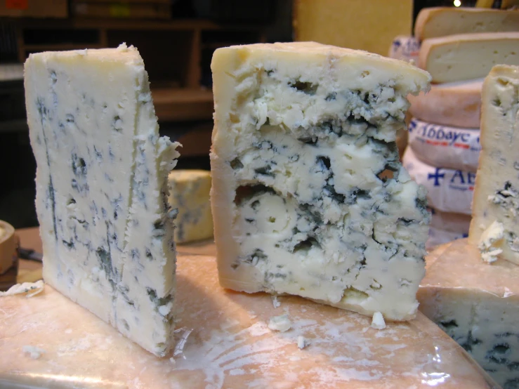 the piece of cheese has been covered with blue mold