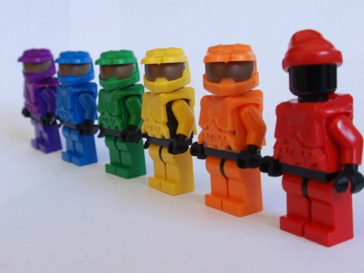 a row of lego figures wearing a different colored outfit