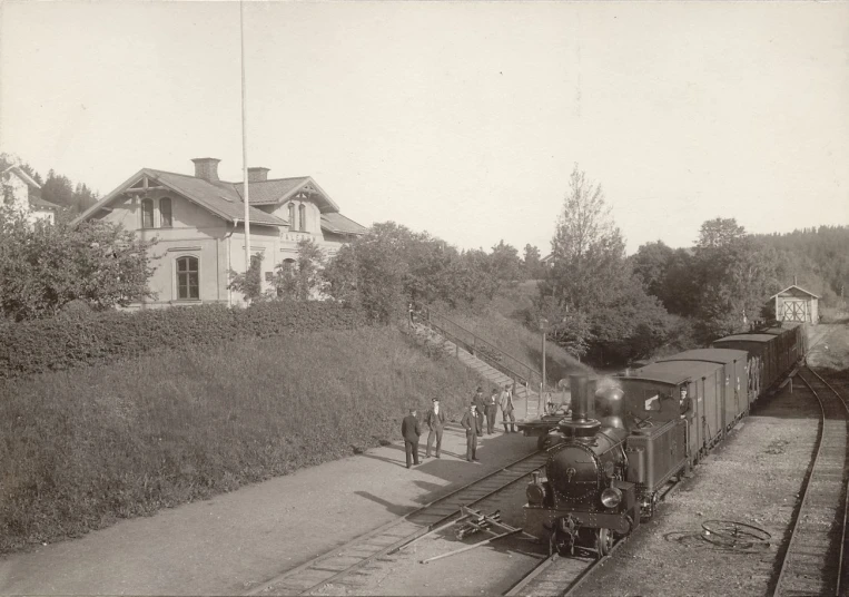 an old black and white po with people by a train