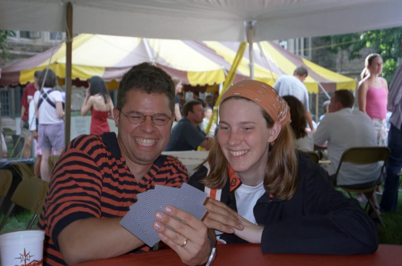 an image of a man and woman smiling at a dinner table