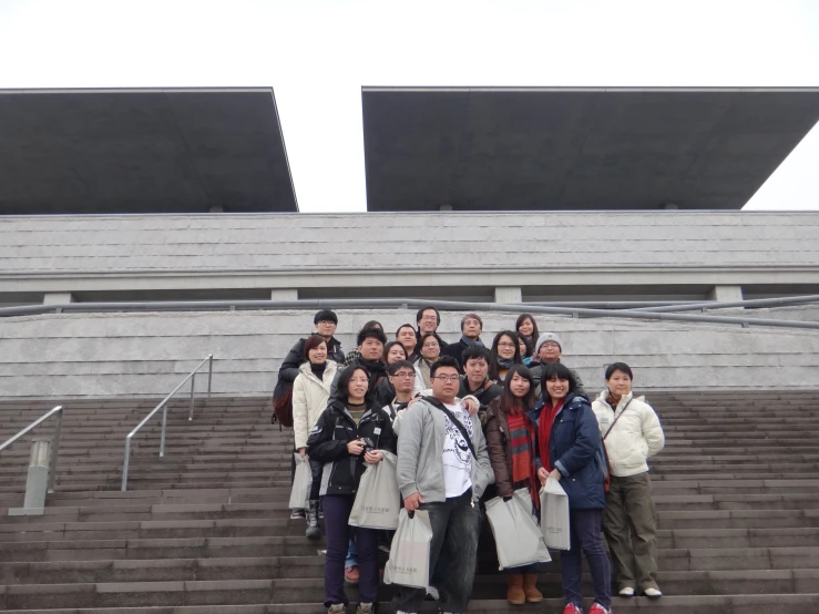 many people standing on steps outside in front of a building