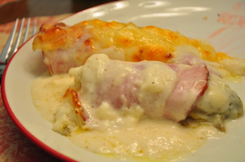 a plate with pasta and meat covered in sauce