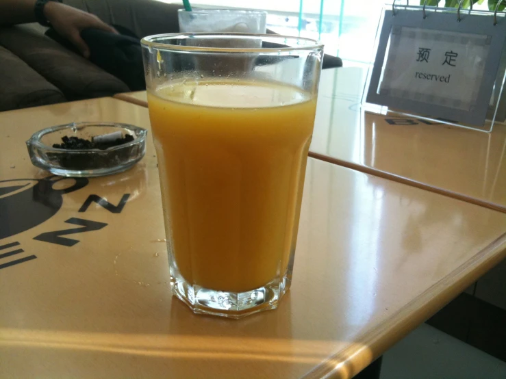 a drink in a tall glass sitting on top of a table