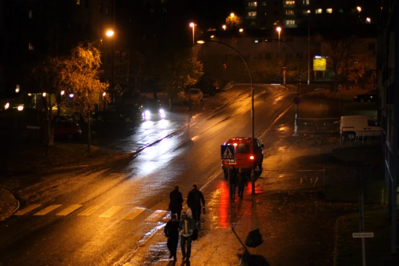 two people are walking down a street in the rain