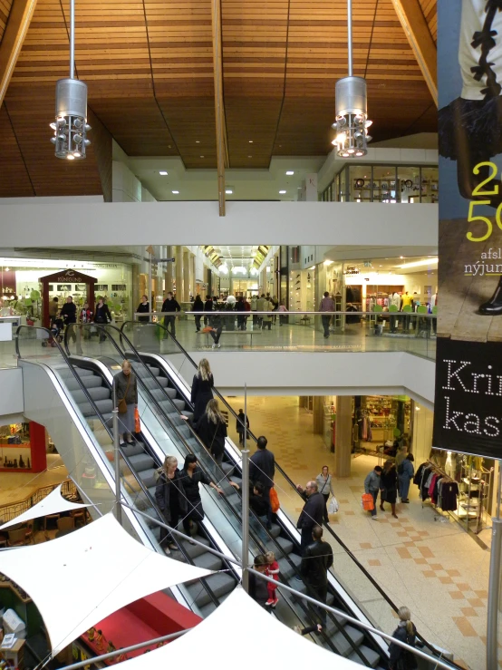 there are some people sitting at the escalator