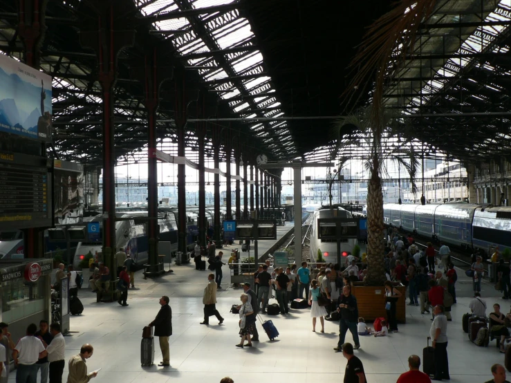 a train station with lots of passengers