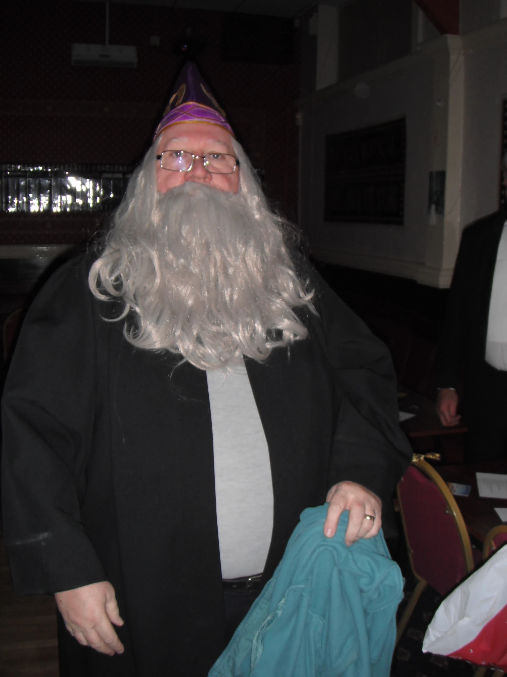 a man with a very long gray beard wearing a santa claus costume