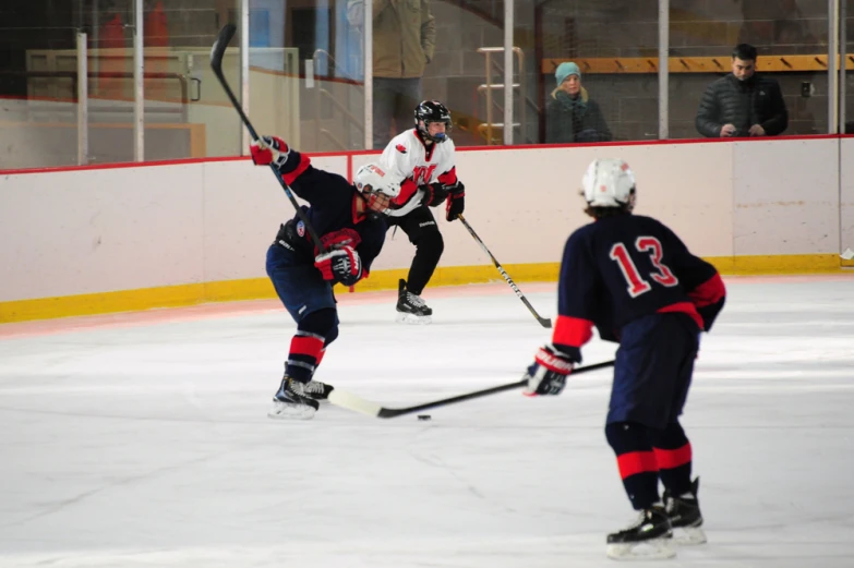 two men playing ice hockey on an indoor rink