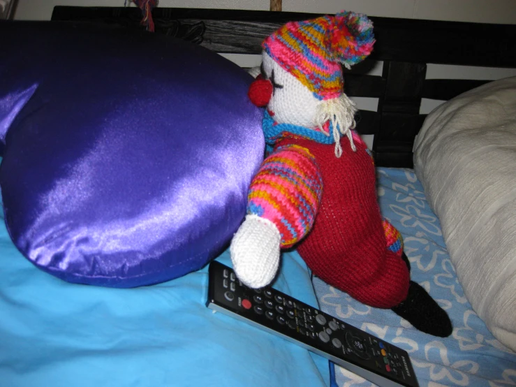 a stuffed horse and an arm pillow on a bed