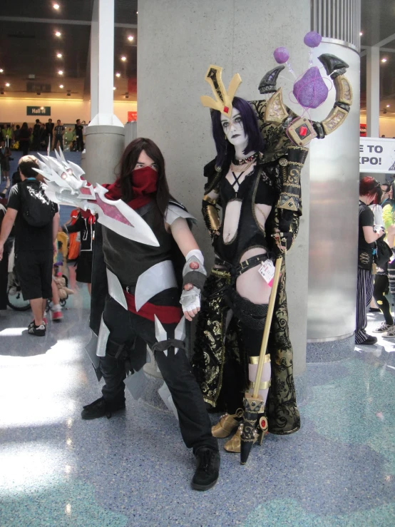 two women in cosplay costumes holding a white bat