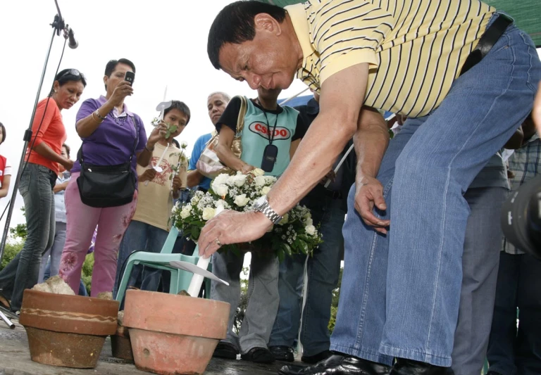 a man placing some flowers on a chair