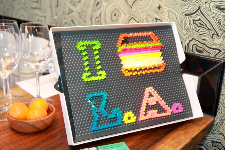 a sign made out of small beads and plastic letters