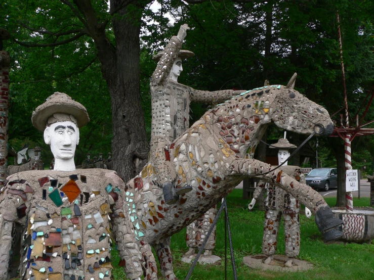 a group of sculptures of people in fancy outfits with horses