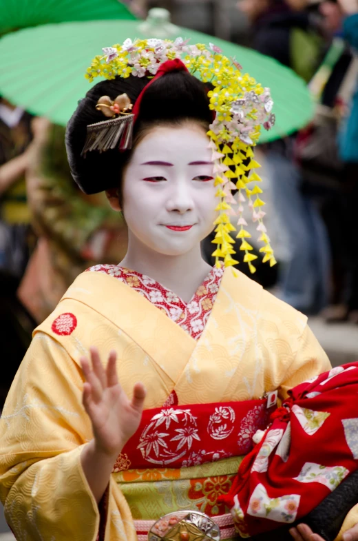 woman dressed in white holding an umbrella and wearing geisha makeup