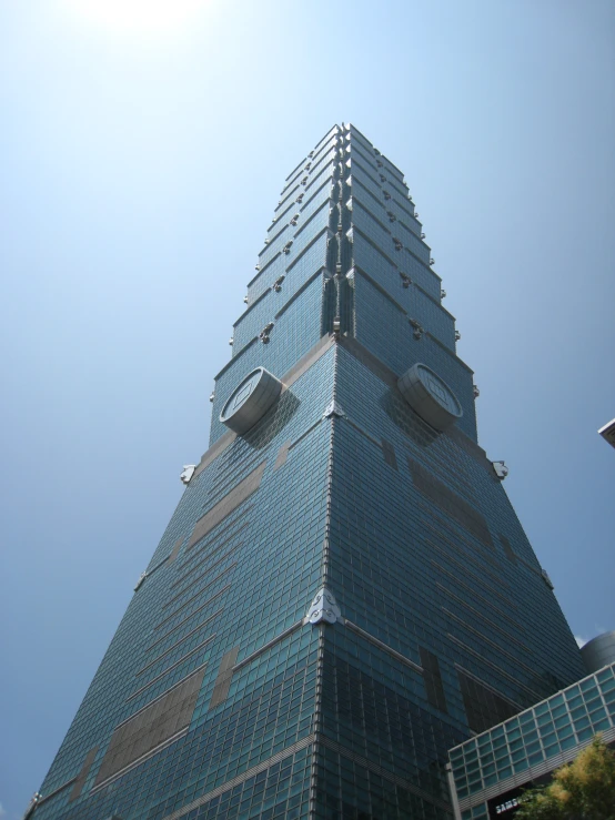 the tall building has a large clock mounted to it