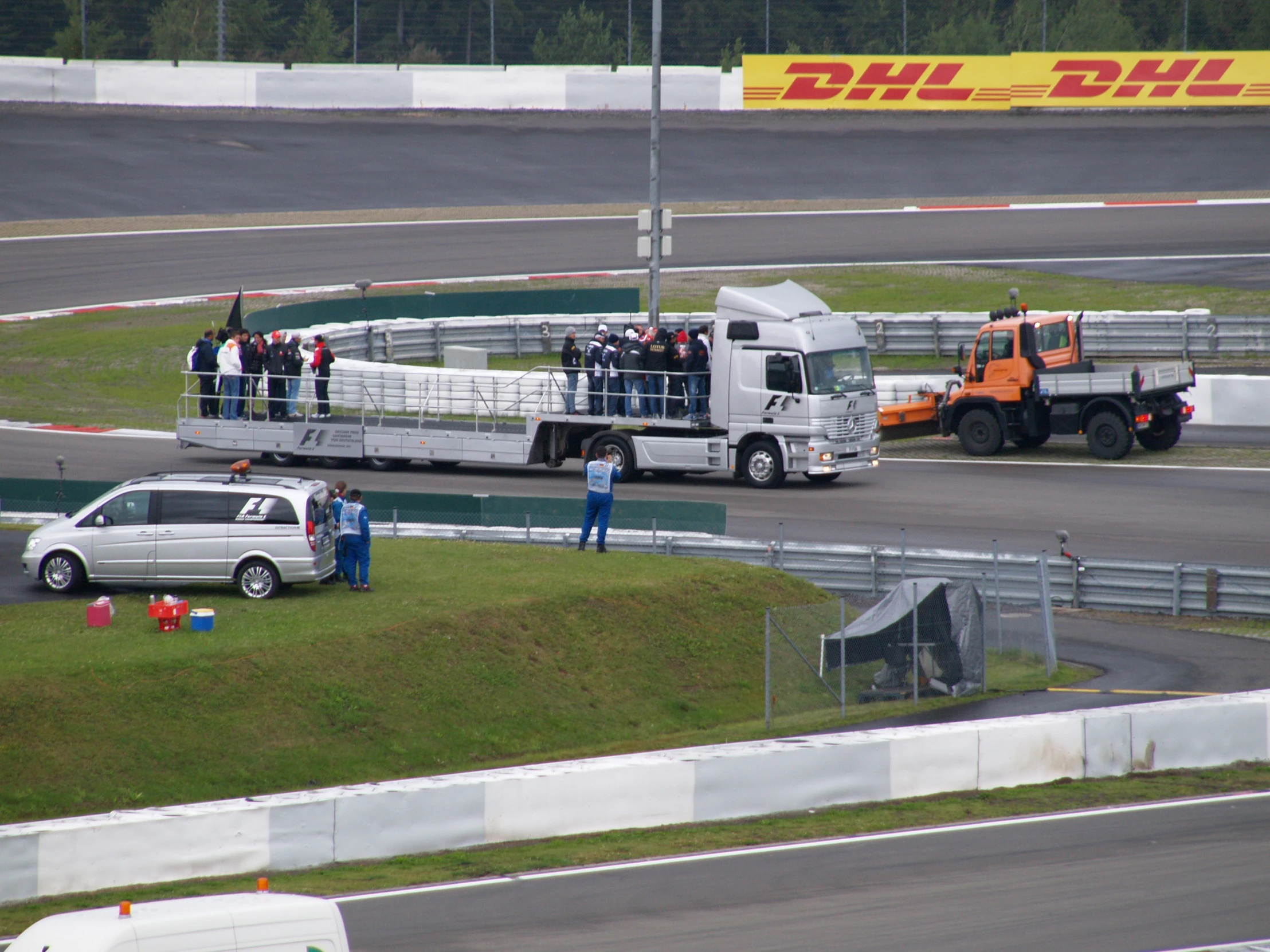 two trucks parked in front of a race track