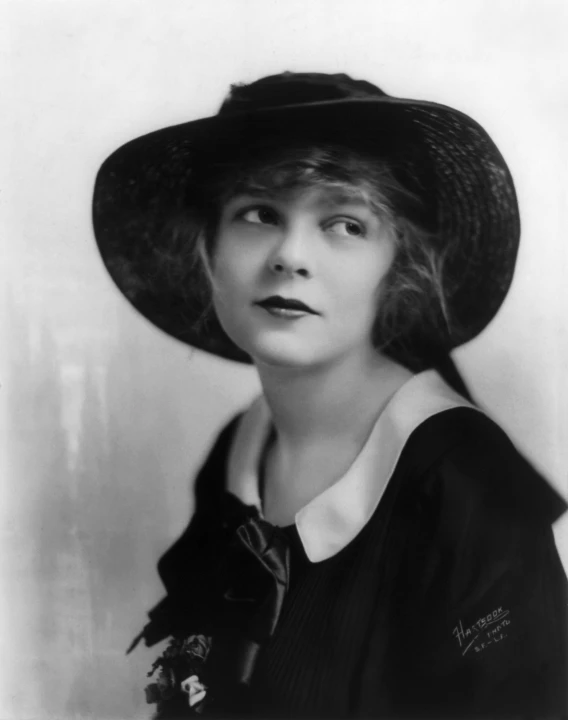 an old po of a young woman wearing a hat