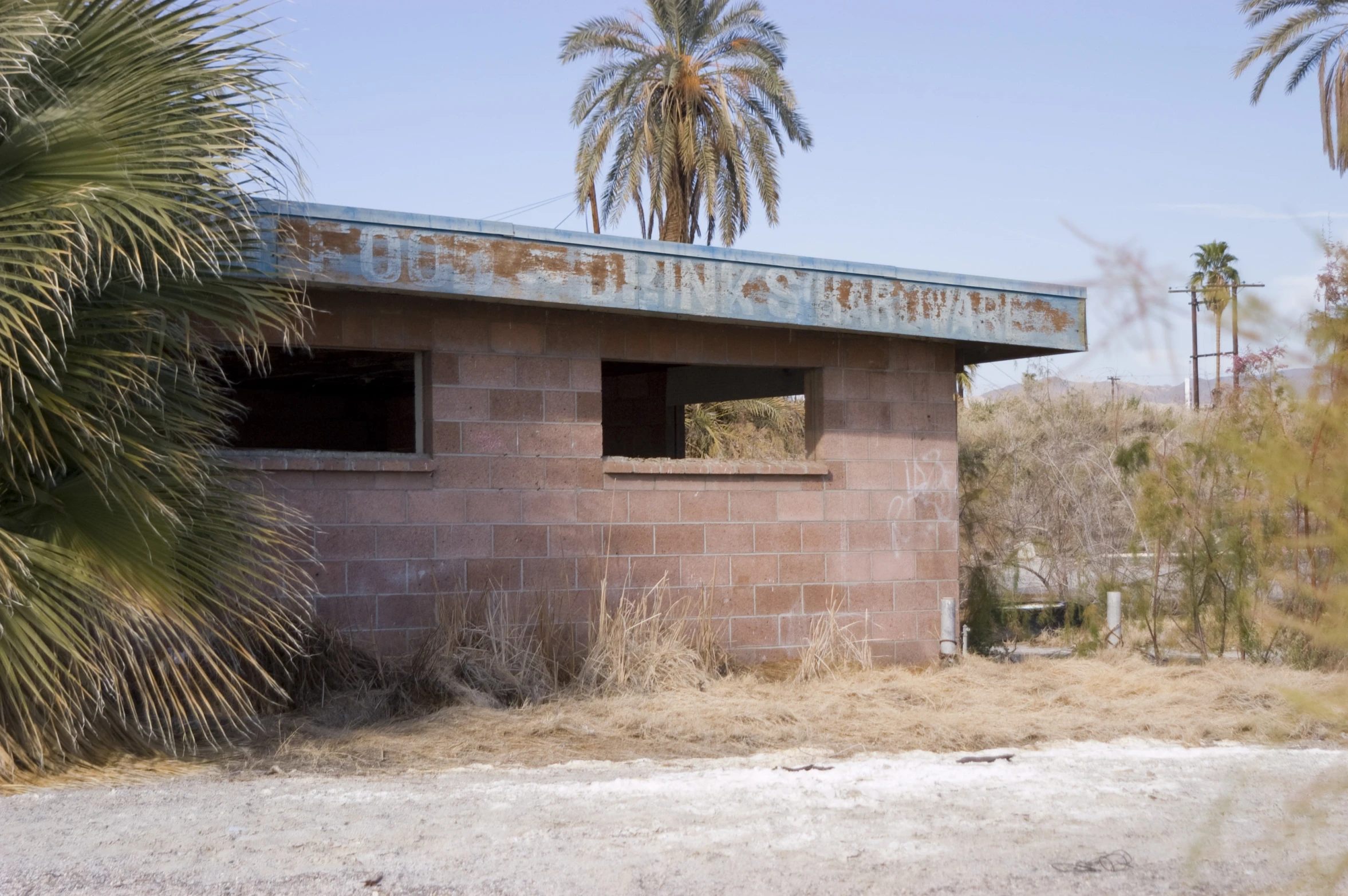 an old rusted up building surrounded by trees