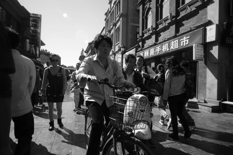 a black and white po of an older man on his bike in china