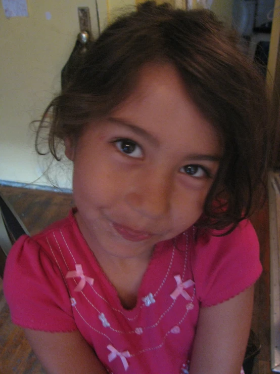 a little girl sitting down in a room