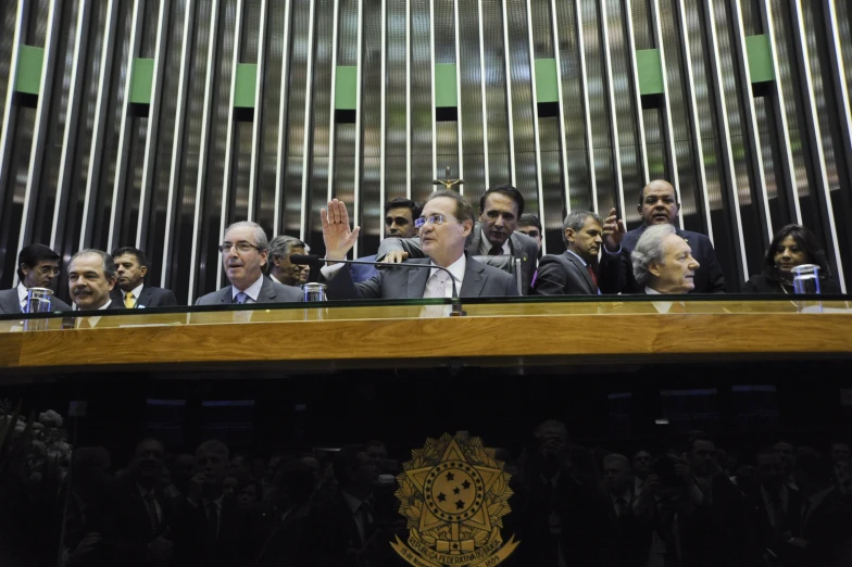 several men standing behind a lecterte during a press conference