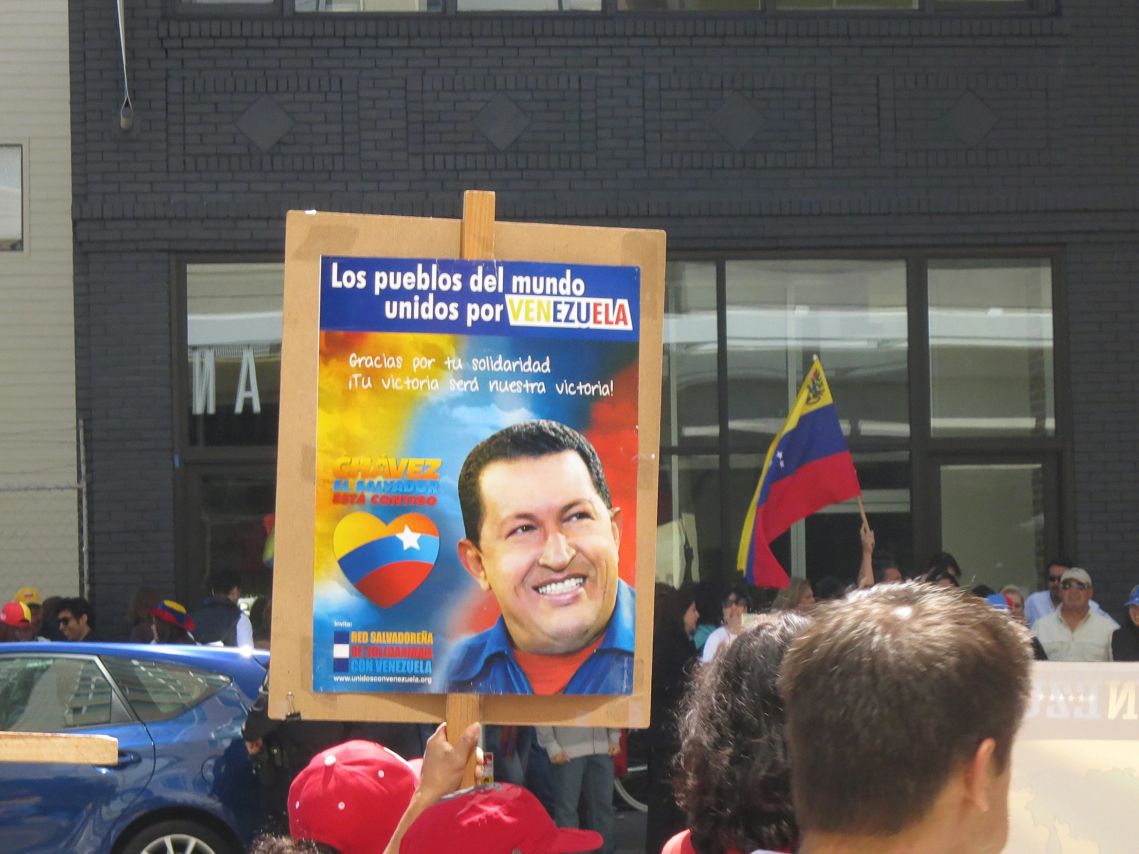 a person holding a political sign in front of a crowd