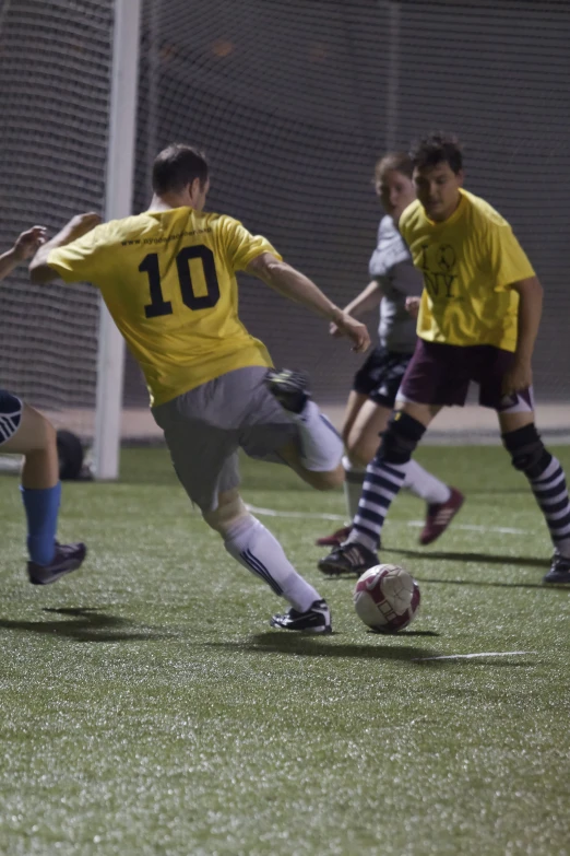 two soccer players kick the ball during the game