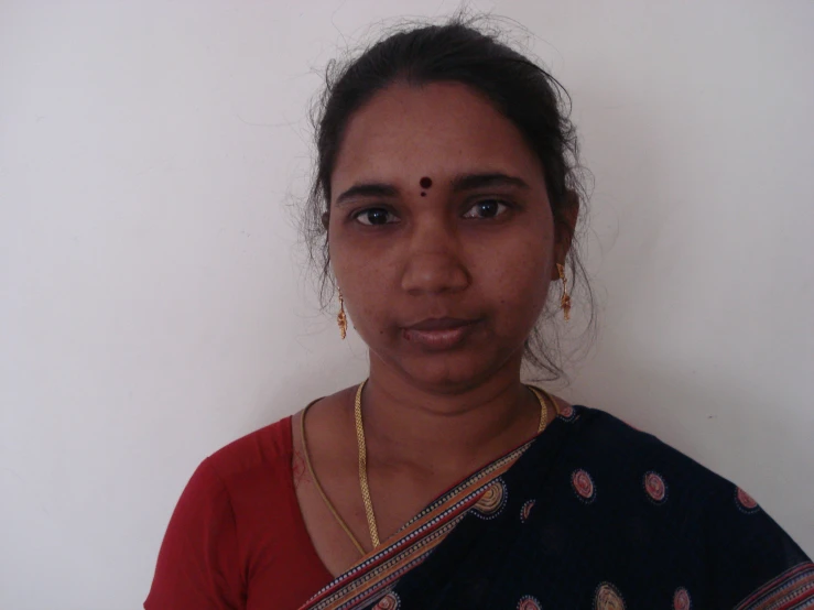 a woman in a red blouse posing for the camera