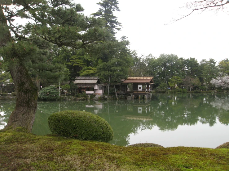 a lake with several water sources with building in the background