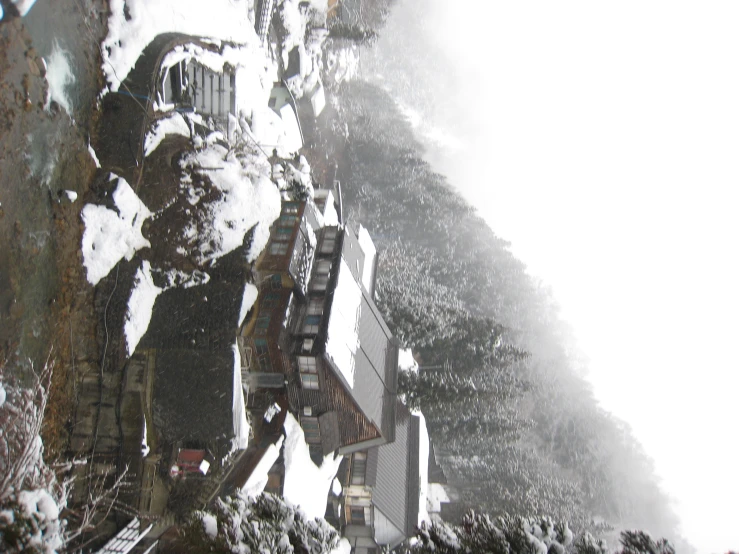 winter scene of snowy houses with snowy mountains