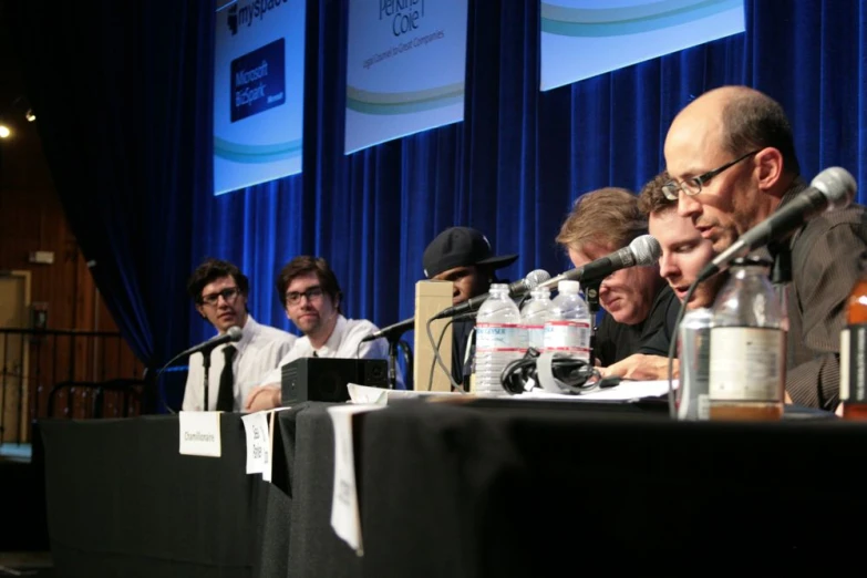 a group of people in suits and ties at a table