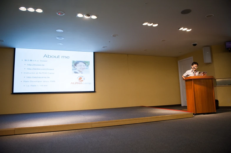 a person standing at a podium giving a presentation