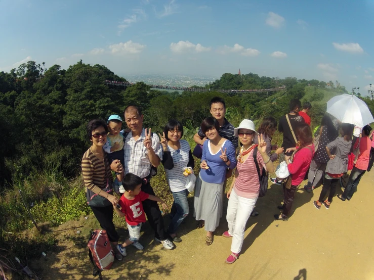 a group of people are posing together at the top of the hill