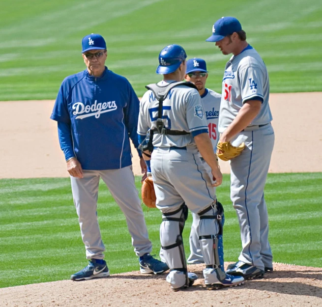 some baseball players are standing by the dugout