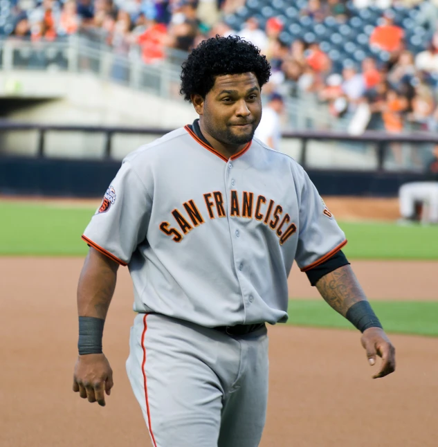 a man with an afro in grey baseball uniform