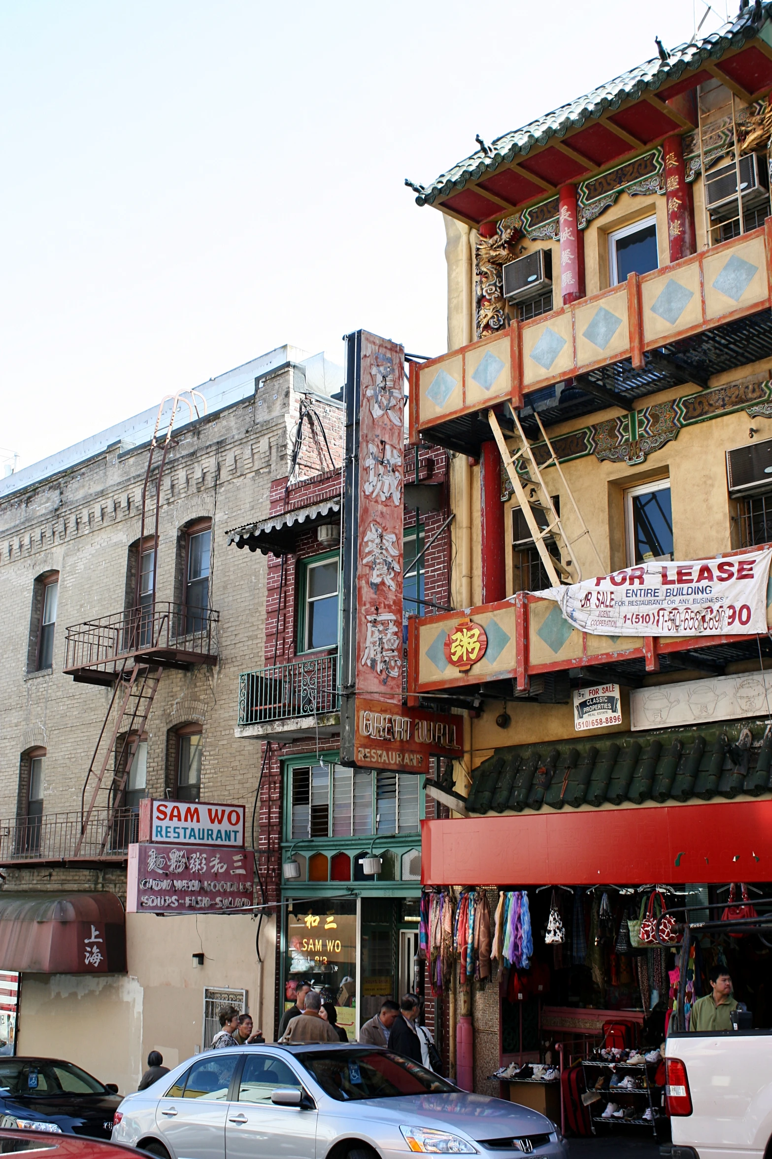 the shop front is red and tan and has several shops