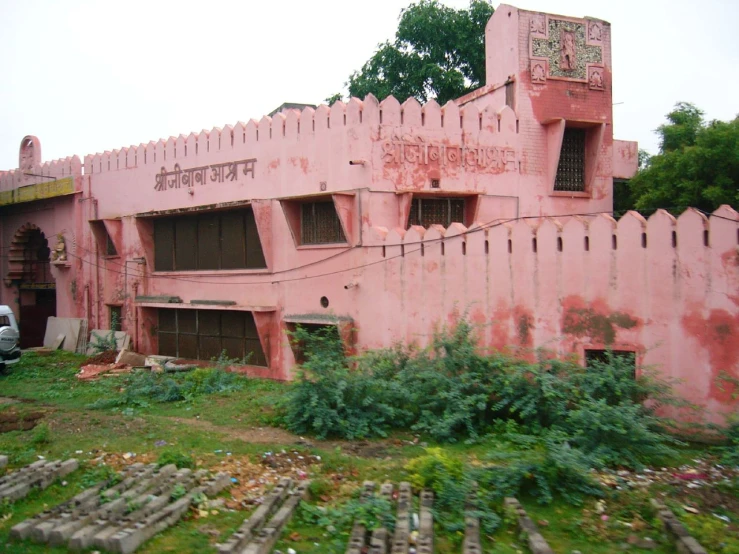 a truck parked in front of a pink building