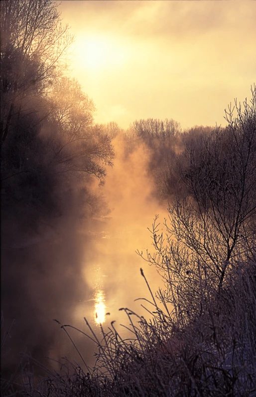 an image of sunset on the river in the winter